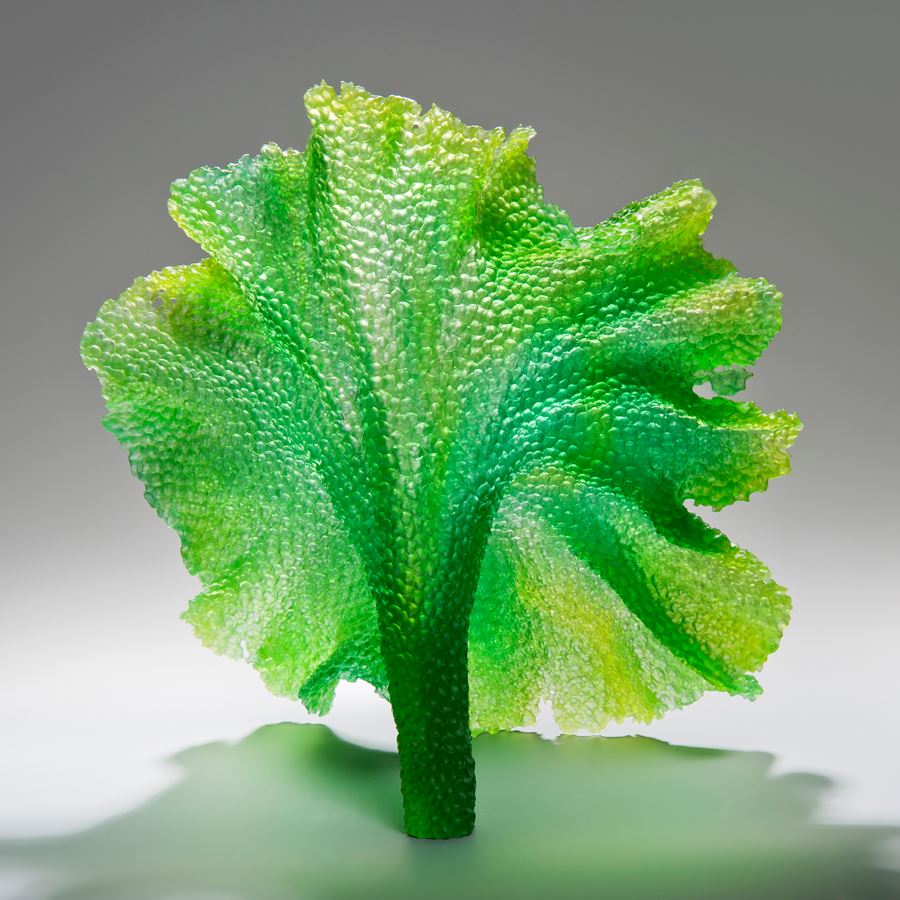 glass art sculpture of leaf in bright green