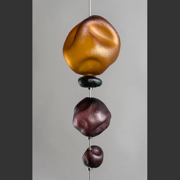 hanging art glass sculpture of brightly coloured pebble shaped glass pieces in rectangular frame