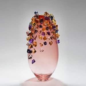 pink sculpted glass vase with colored crystals adorning the outer edges