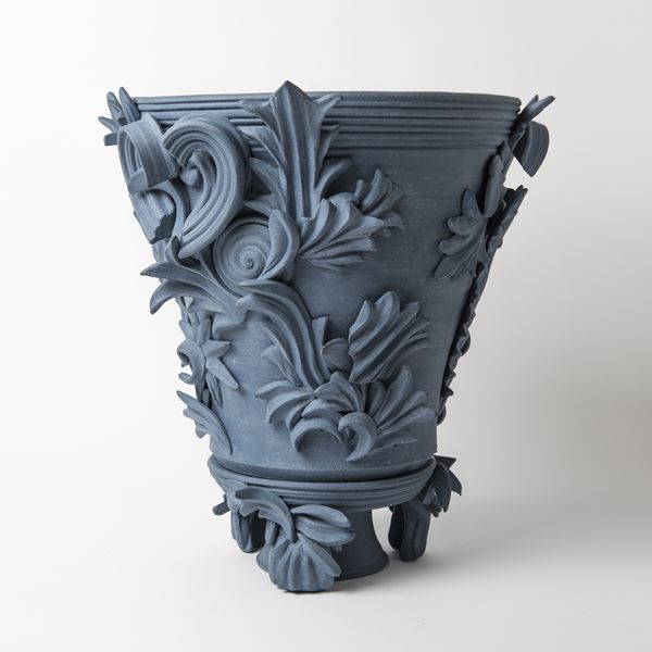 blue contemporary ceramic vase sculpture in classical style with classical flower trim 