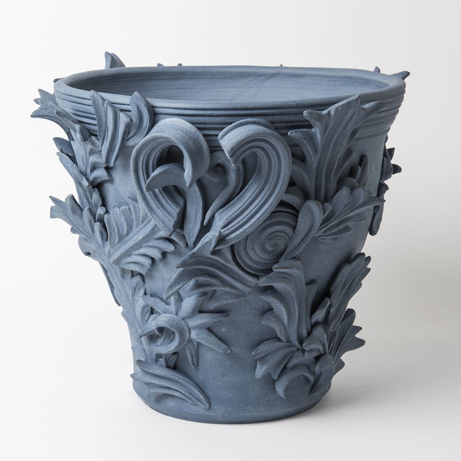 blue contemporary ceramic vase sculpture in classical style with classical flower trim 