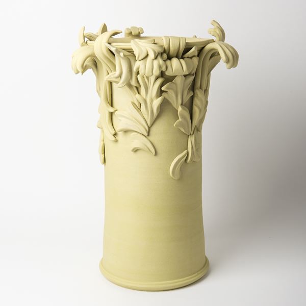 yellow contemporary ceramic vase sculpture in classical style with classical flower trim 