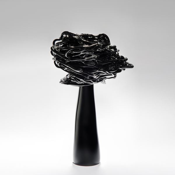 black decorative art-glass ornamental sculpture of a flower in wind