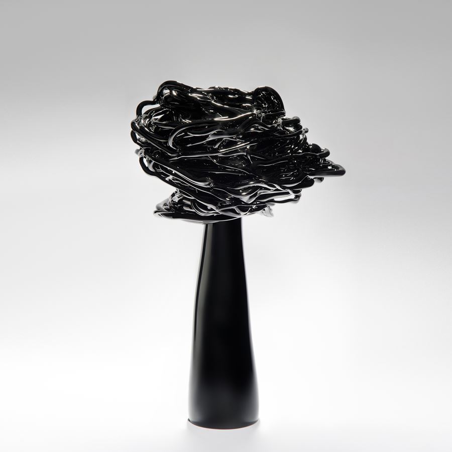 black decorative art-glass ornamental sculpture of a flower in wind
