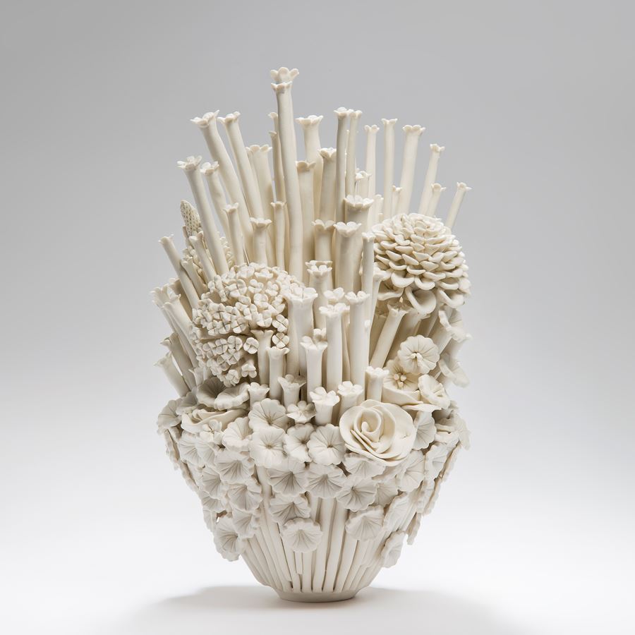 white porcelain sculpted artwork of roses sprouts and flowers