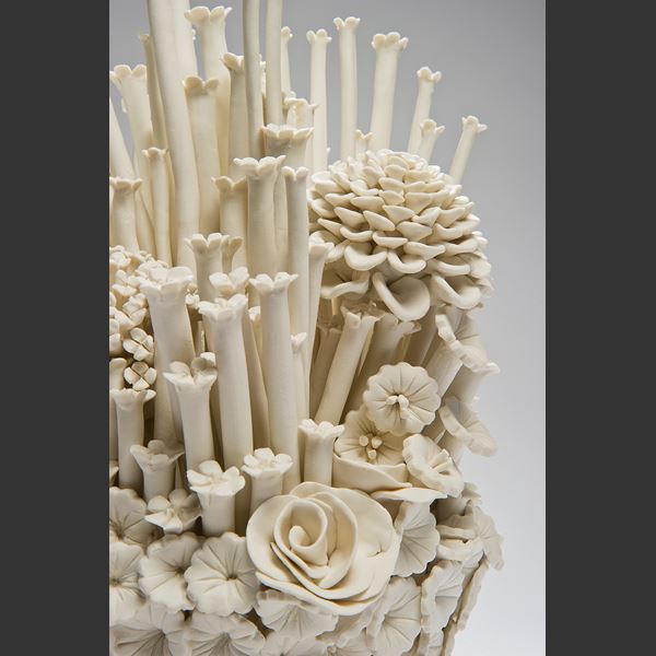 white porcelain sculpted artwork of roses sprouts and flowers