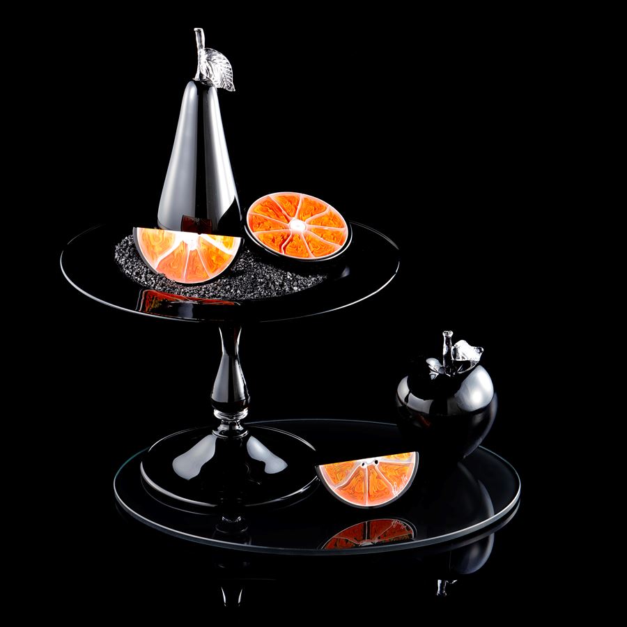 still life artwork in black carbon and orange made from handblown and sculpted glass