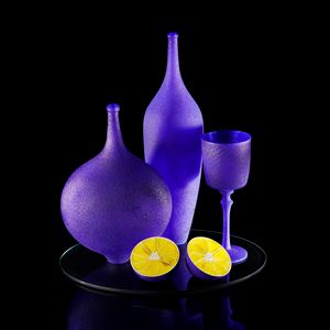 handblown and sculpted glass art still life in blue and yellow of lemons and ornaments