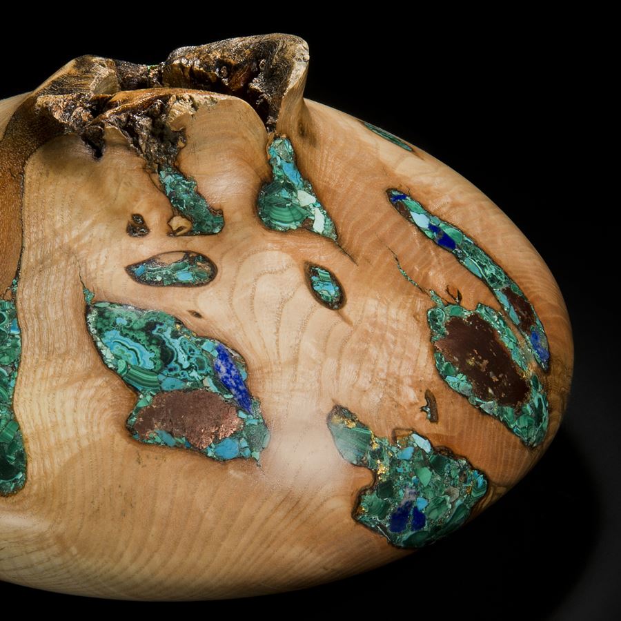 wide sculpted vessel made from ash inlaid with precious minerals in green and gold