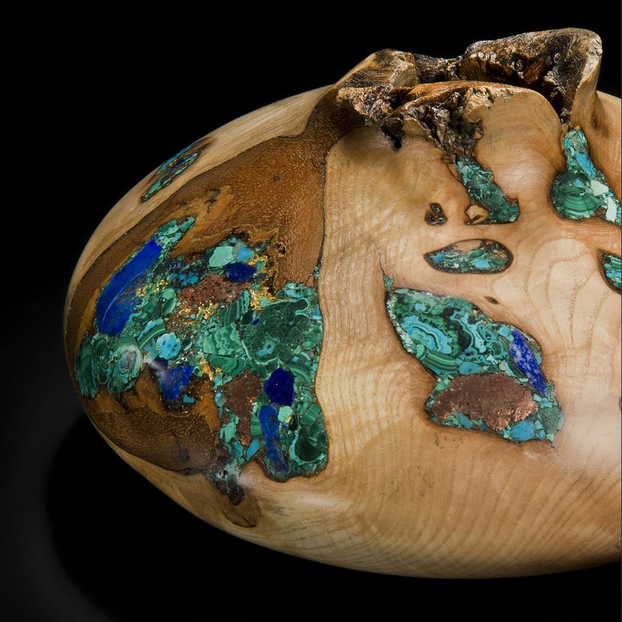 wide sculpted vessel made from ash inlaid with precious minerals in green and gold