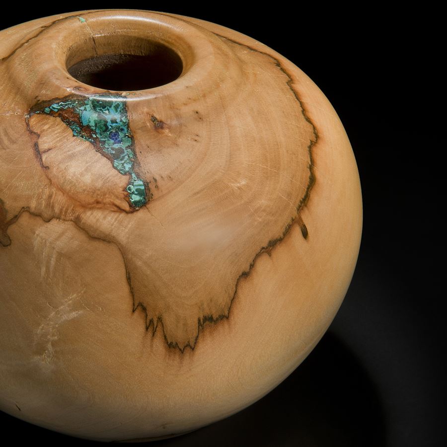 sculpture of vessel made from sycamore in creamy brown inlaid with precious minerals