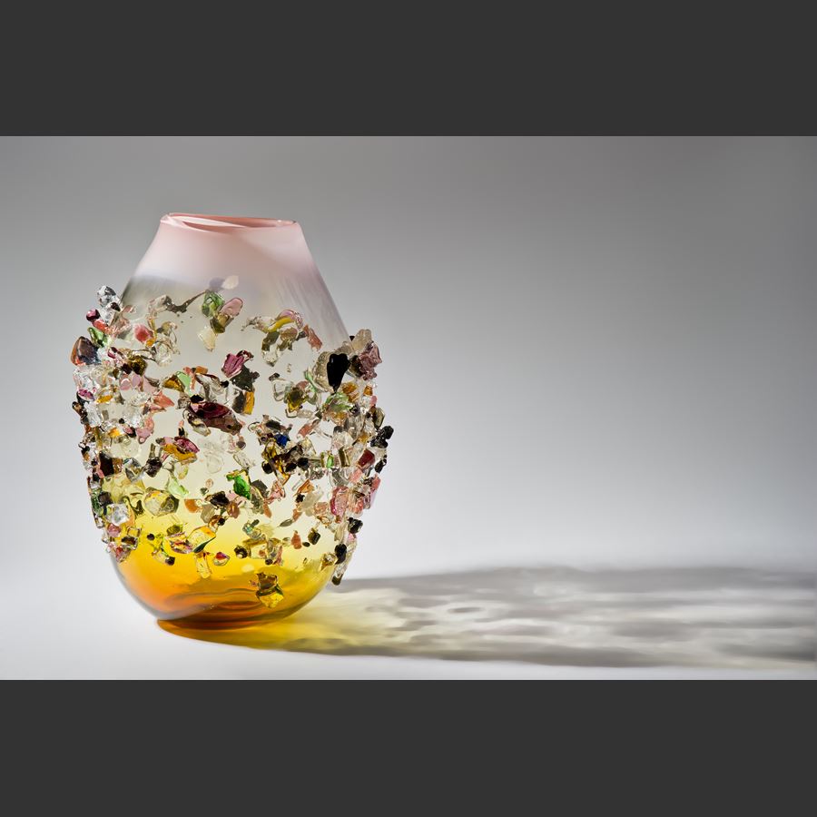 handblown glass vessel in amber and clear colours with multicoloured crystal adornments