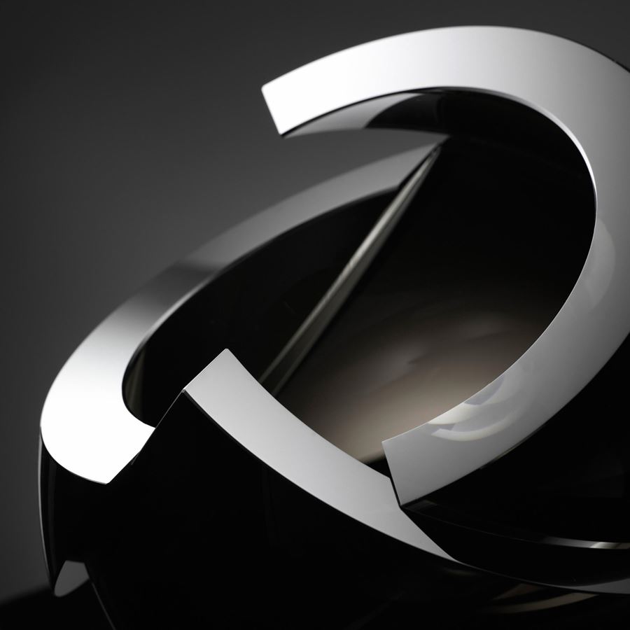 modern minimalist spherical art glass sculpture with sharp cuts in black