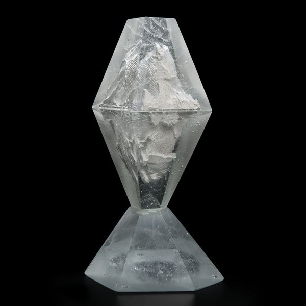 glass and plaster sculpture made to look like something trapped in diamond cut ice