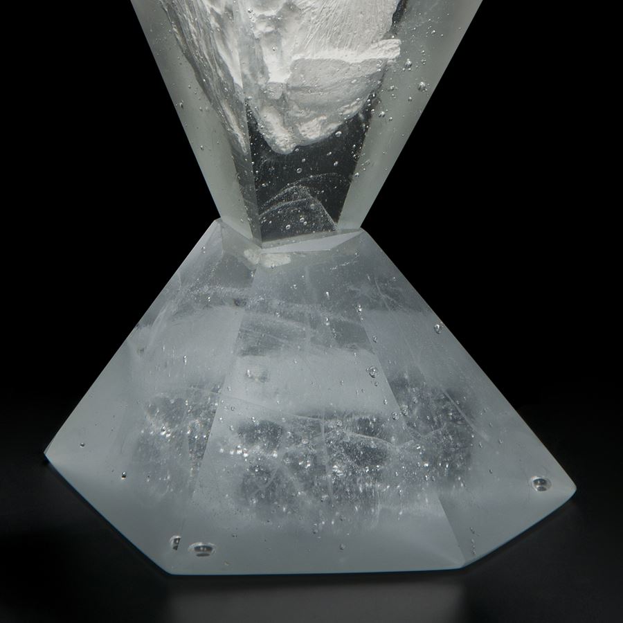 glass and plaster sculpture made to look like something trapped in diamond cut ice