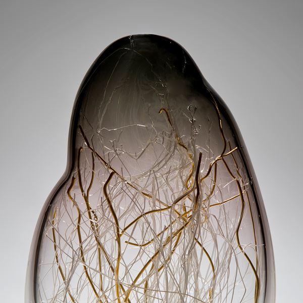 sculpted glass vessel in grey and yellow with internal wire structure