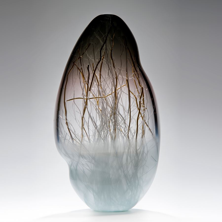 glass art vessel sculpture in grey and light blue with internal gold wire structure