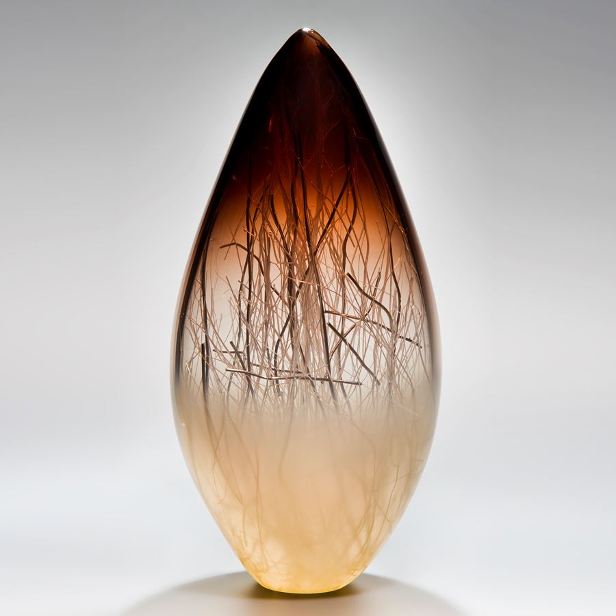 art glass sculpture in brown and cream with internal wire structure
