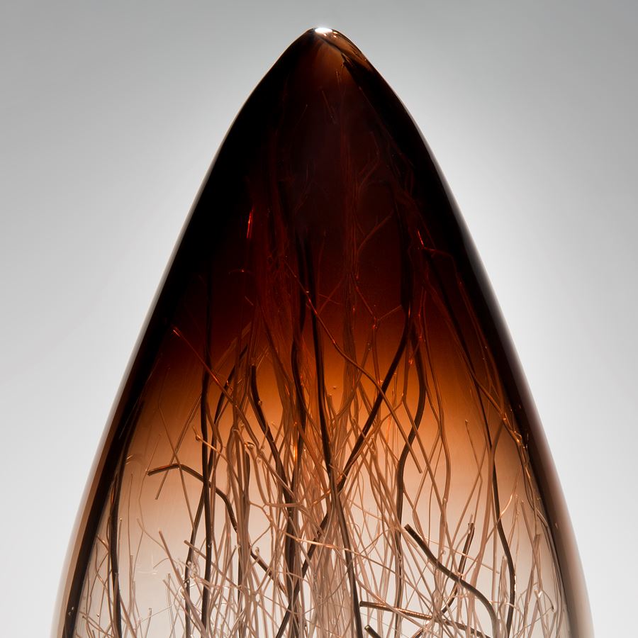 art glass sculpture in brown and cream with internal wire structure