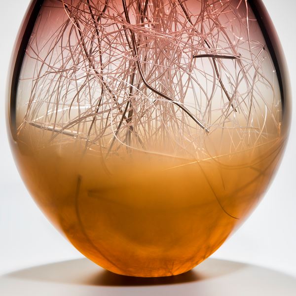 art glass sculpture in orb shape with aubergine and coffee colours and internal wire structure