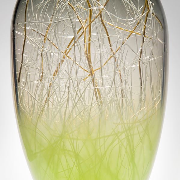 tall blown glass orb with internal gold wire structure and lime coloured base