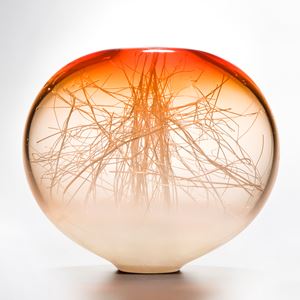 orange coloured apple shaped glass ornament with internal structure resembling tree branches