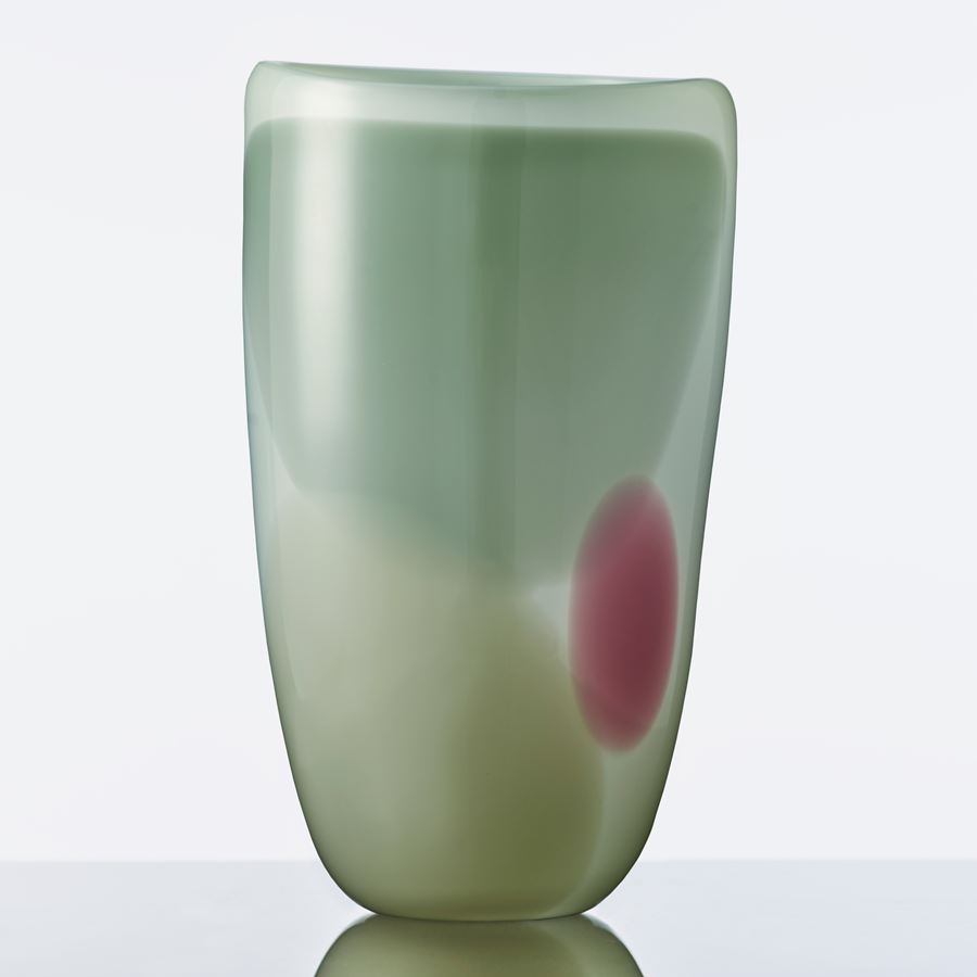 modern glassware vessel sculpture in shades of green with small purple patch