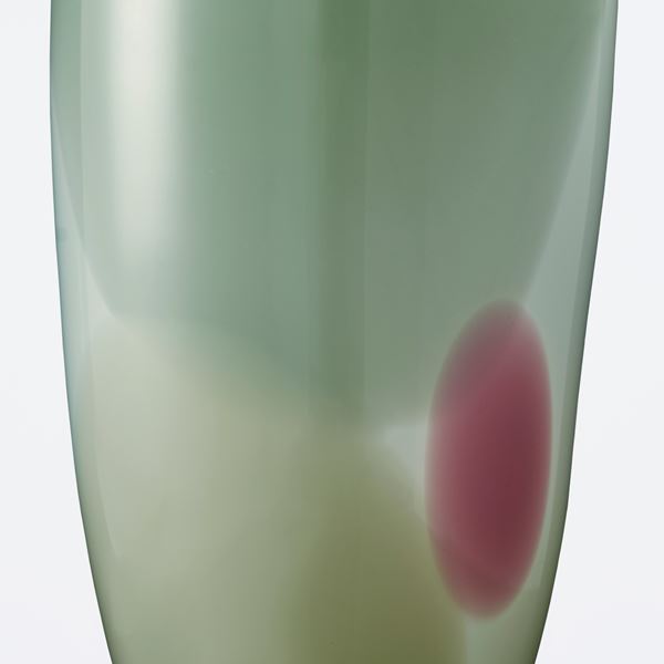modern glassware vessel sculpture in shades of green with small purple patch
