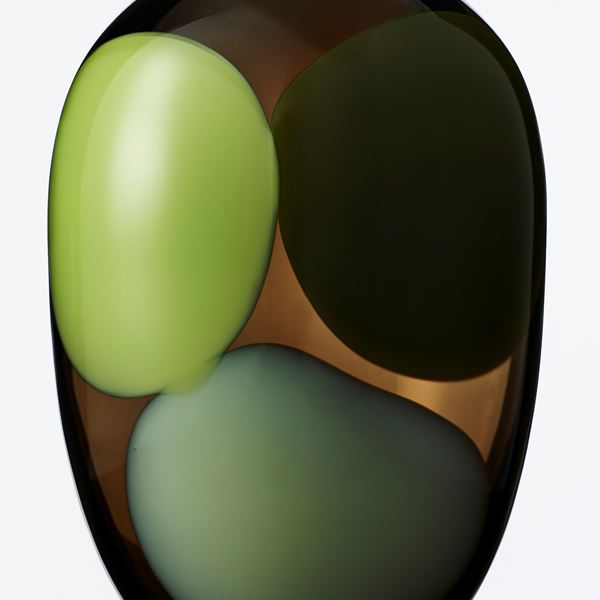 modern art glass vase in dark brown with light green grey and black blobs