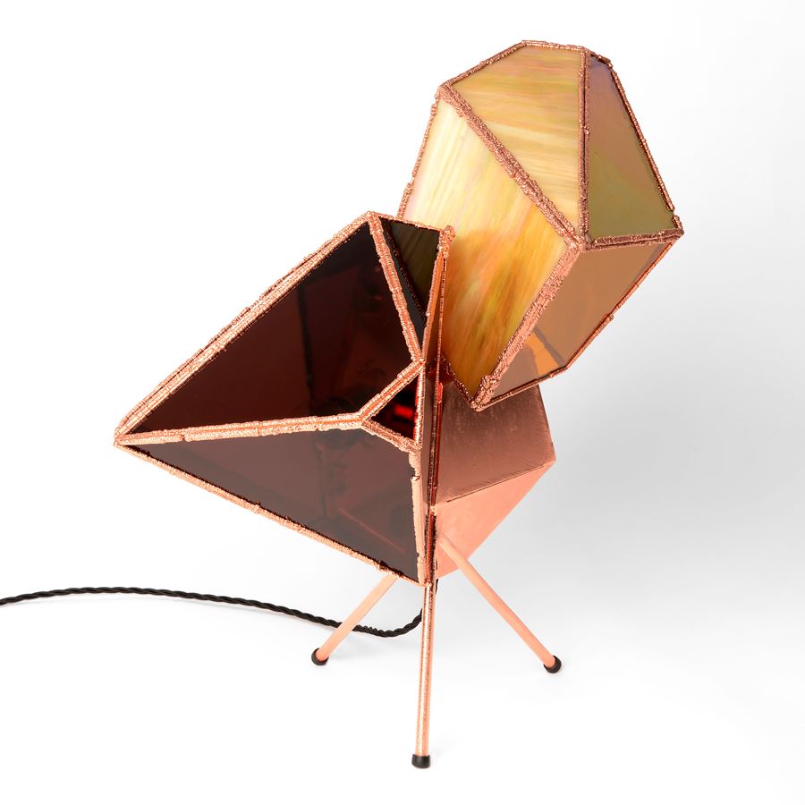 table light with copper base and angled shaped glass in gold pink and ruby