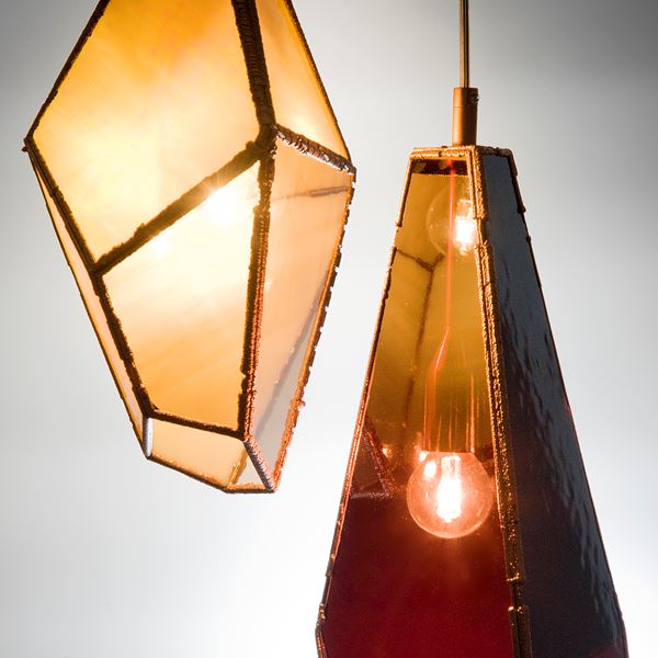 hanging pendant lights in bronze and rich coloured glass