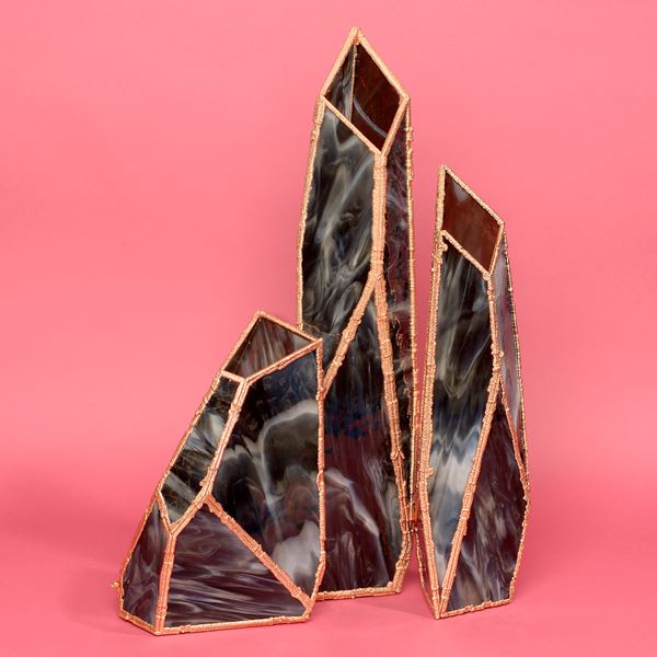 four crystal shaped vases in marbled black with copper frames