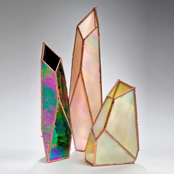 three crystal shaped glass art vases in oil coloured glass and copper frame