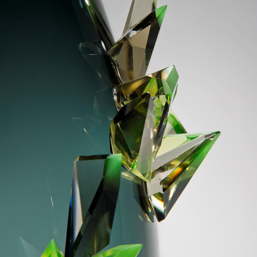 minimalist glass vase sculpture in light to dark turquoise with green external crystals