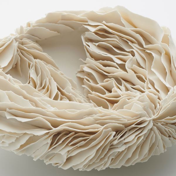 white porcelain art sculpture of flat bowl with feathered appearance