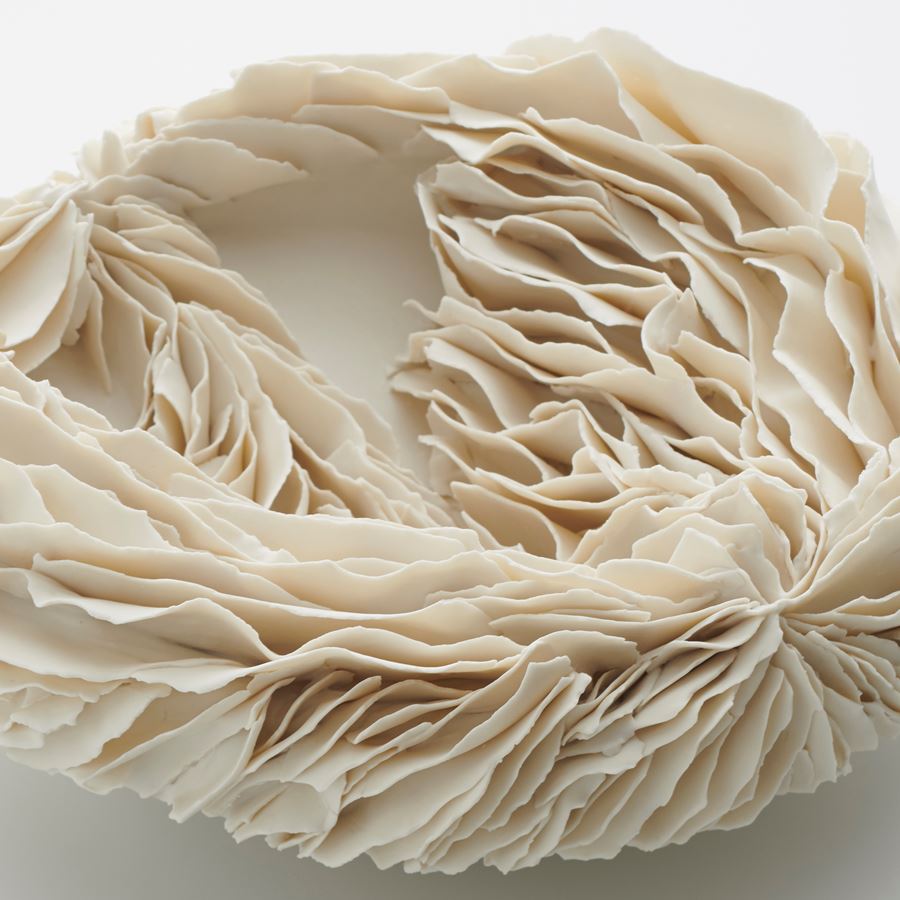 white porcelain art sculpture of flat bowl with feathered appearance
