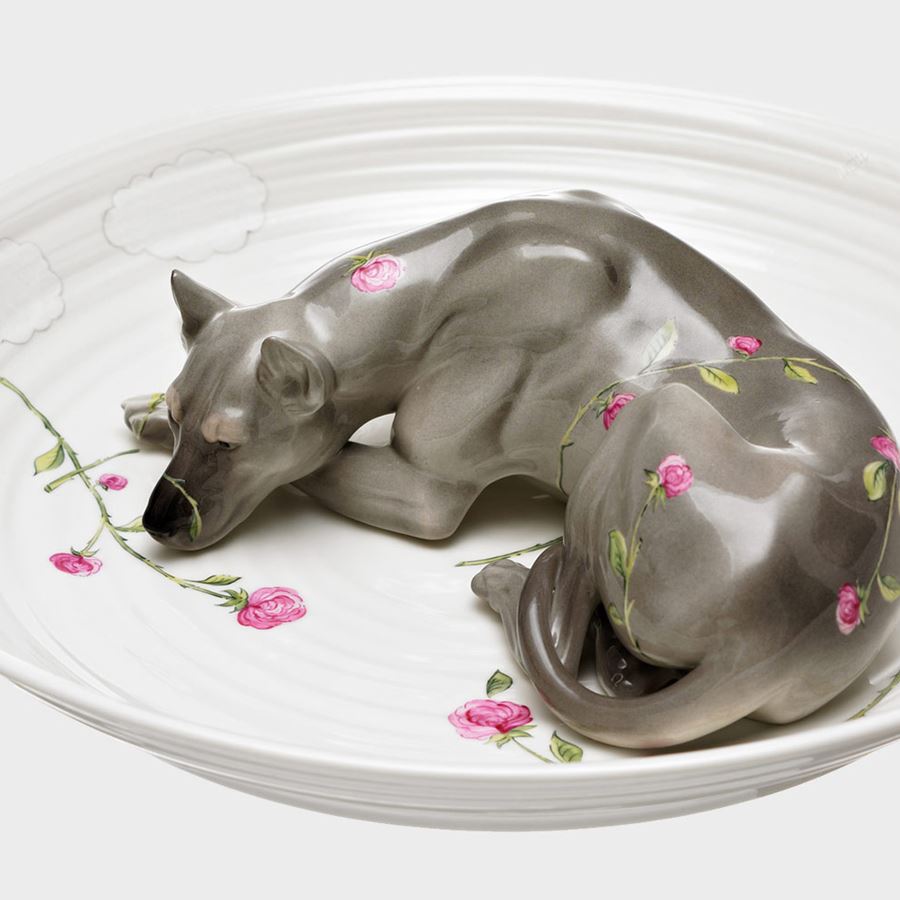 porcelain sculpted bowl in white with porcelain sculpted model of a dog resting in the centre