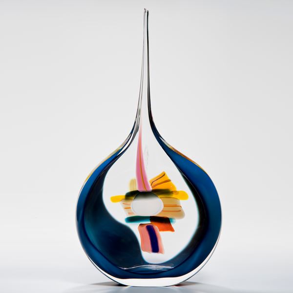 abstract glass vase with round blue and white base and long pencil thin clear top