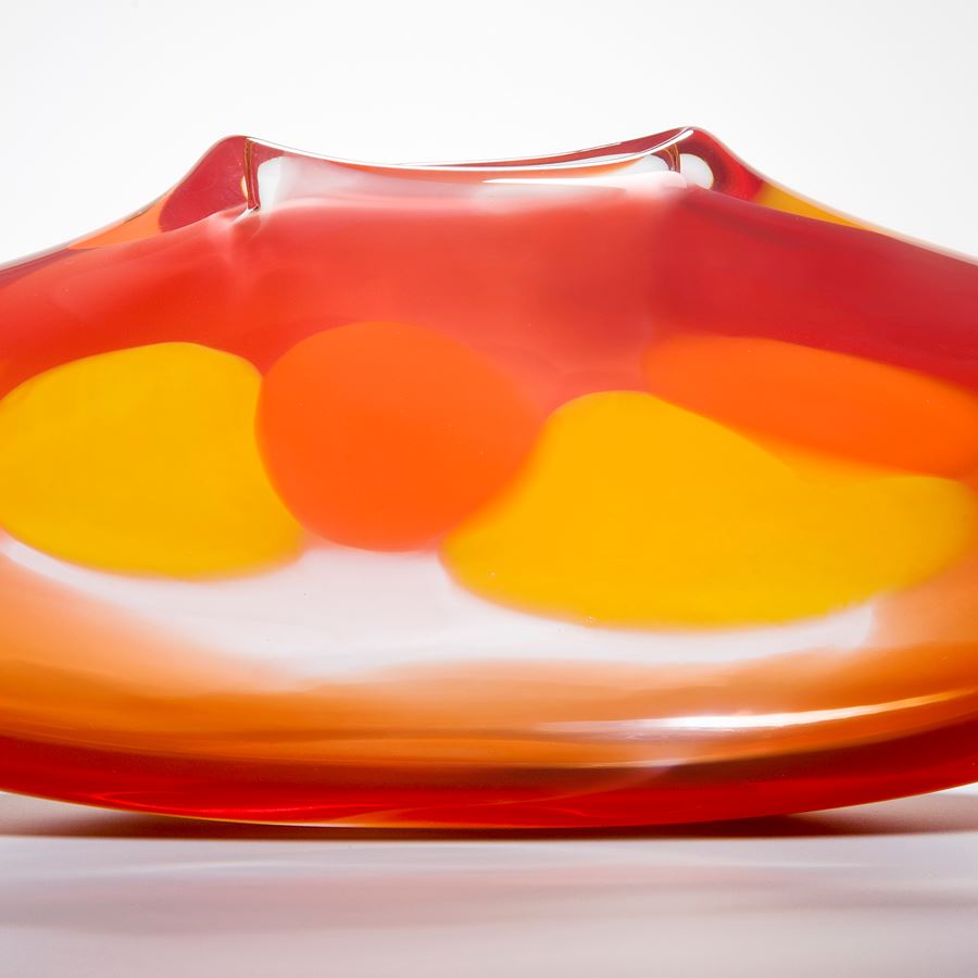abstract orange glass art vase with yellow dots