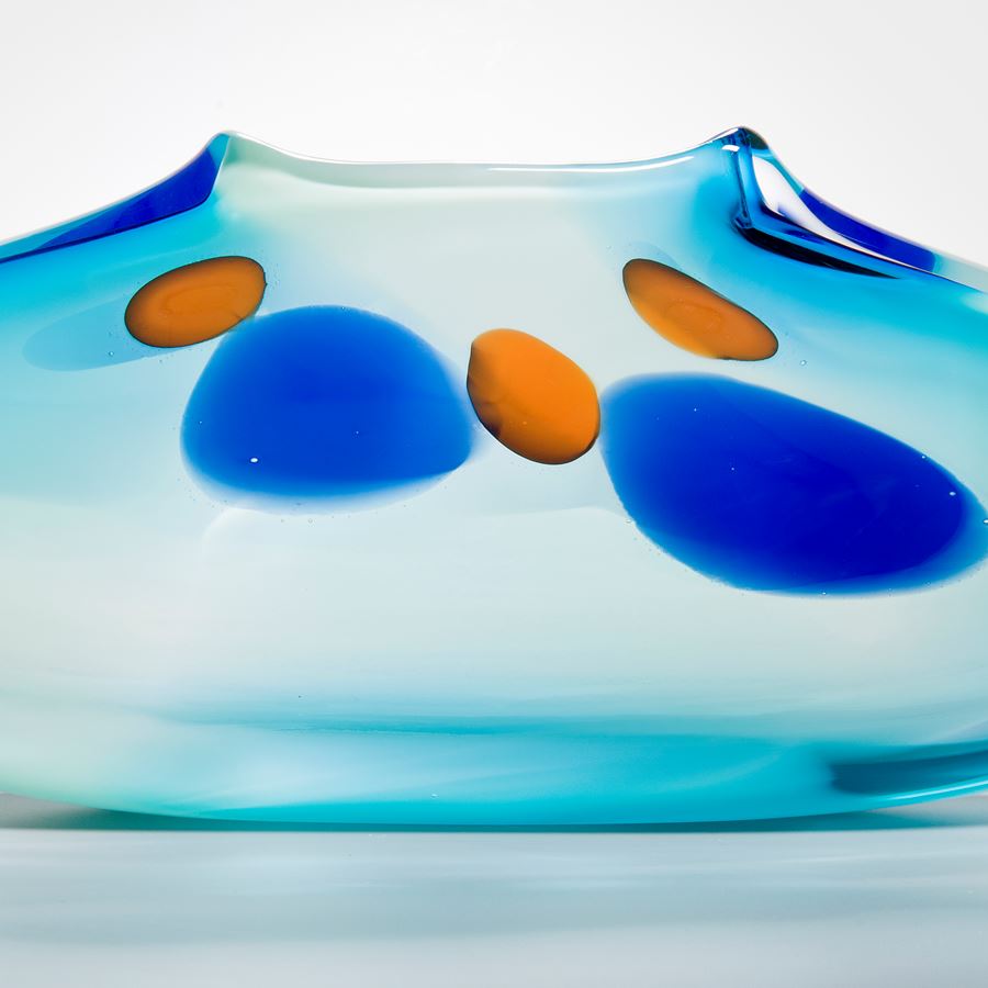 abstract turquoise glass art vase with blue and orange dots
