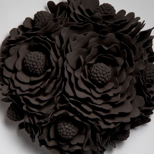 black wall hanging ceramic artwork of flowers