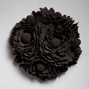 black wall hanging ceramic artwork of flowers