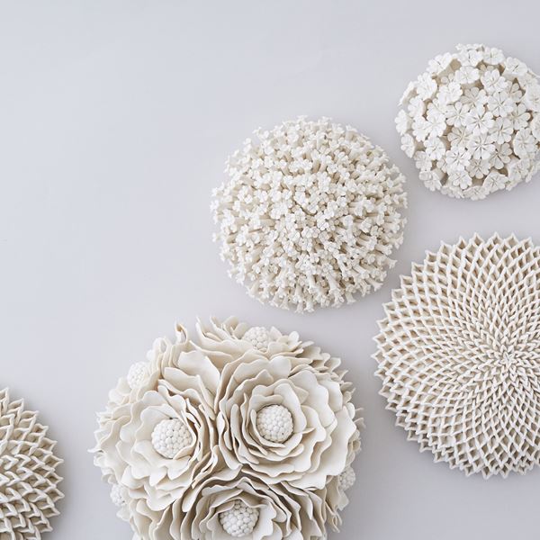 white porcelain art sculpture of daffodils arranged in sphere
