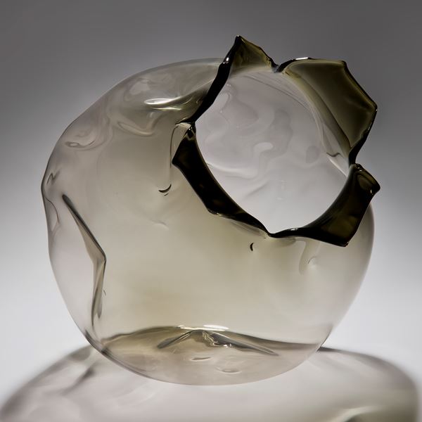 grey art glass sculpture of round fruit with open end