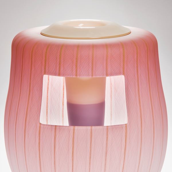 soft peach coloured glass art vessel sculpture with white window-like motif