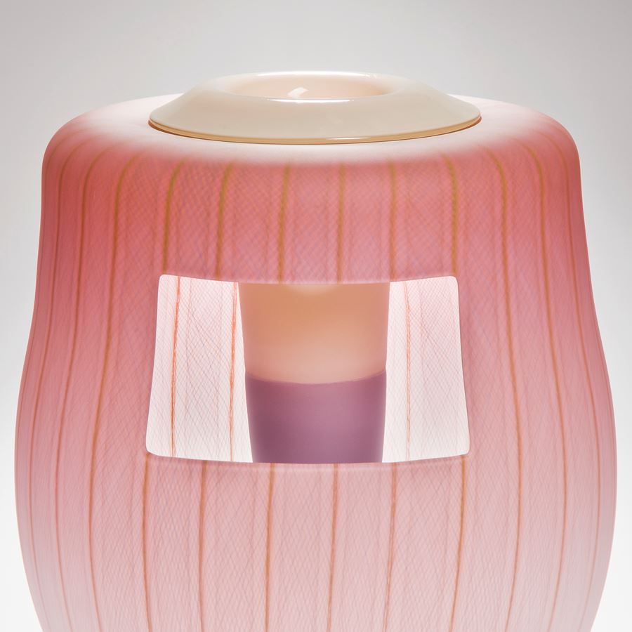 soft peach coloured glass art vessel sculpture with white window-like motif