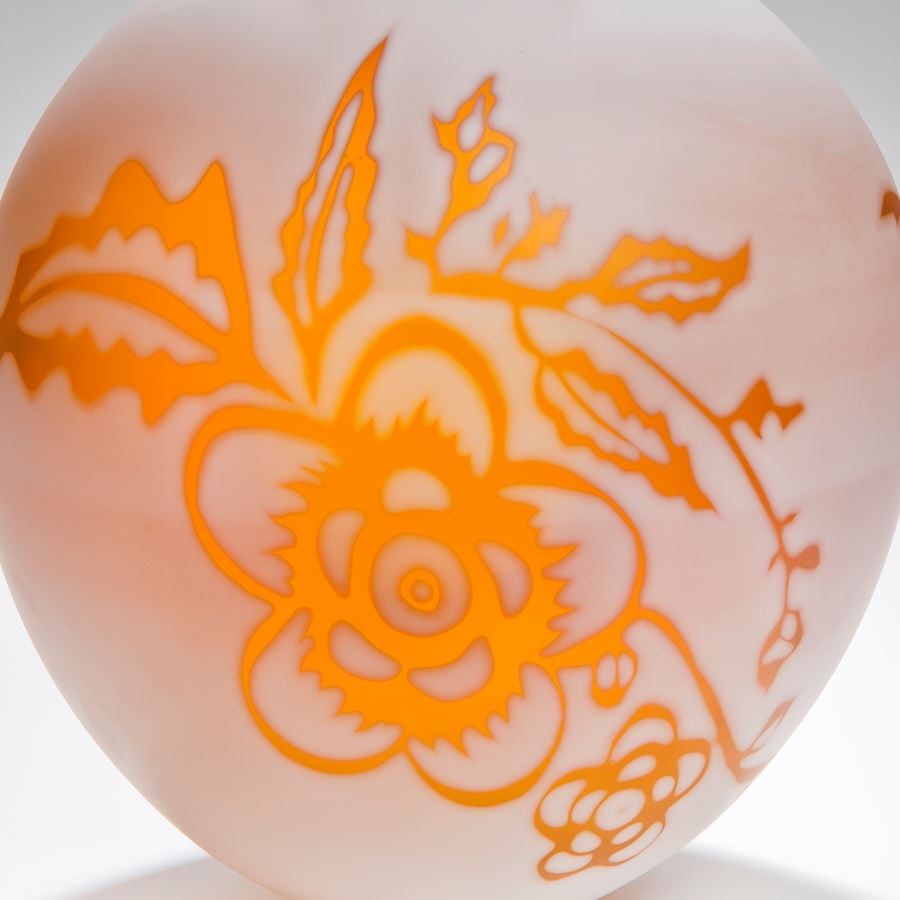 short round cameo glass vase in marble white with bright orange floral motif