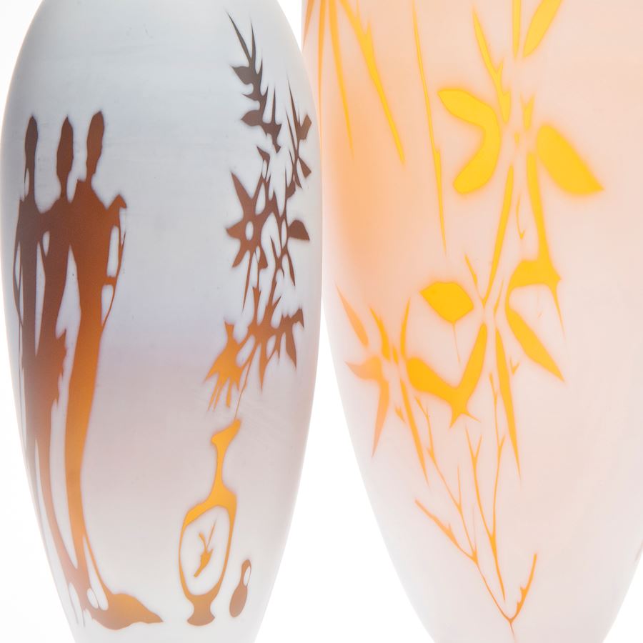 cameo glass vases in white with bright orange and red motifs