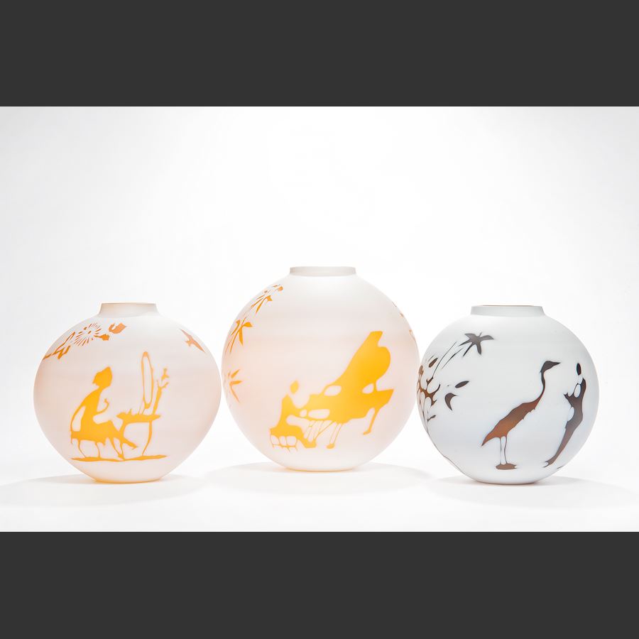 cameo glass vases in white with bright orange and red motifs