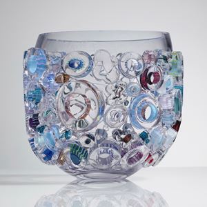 clear glass sculpted vessel with external circular glass adornments